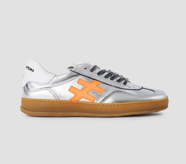 Silver sneaker with orange logo on a gray background